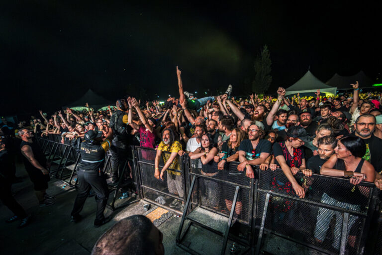 Canada, Granby, 2026-06-05. A concertgoer crowd surfs over the packed audience pressed against the security barriers dur