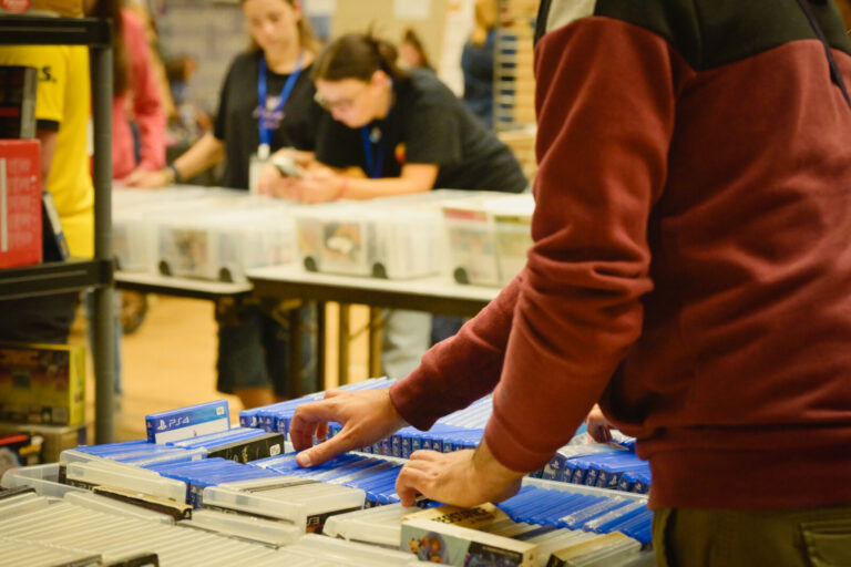 France, Digoin, 2025-09-14. A man searches for a PS4 video game at a stand during the first Digoin Geek Universe convent