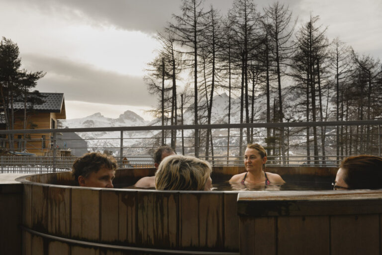 France, Le Devoluy, 2022-03-15. Tourists relaxing in the storvatt (Nordic bath), installed on the outdoor terrace of the