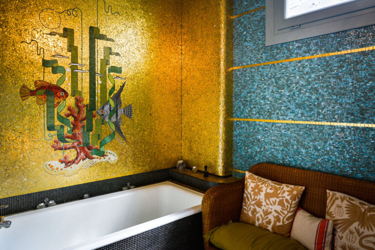 France, Rennes, 2022-05-14. Golden mosaic with fishes in the bathroom of the former residence of the mosaic artist Isido