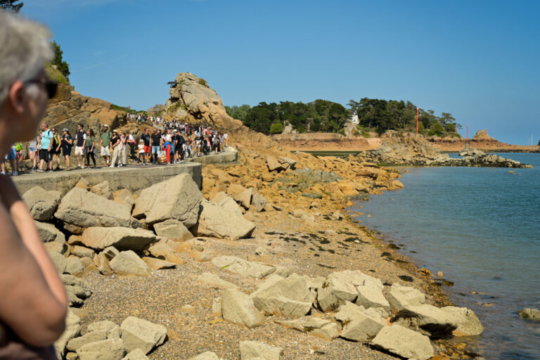 France, Ile-de-Brehat, 2025-05-30. Lots of tourists standing in line to take the shuttle on Brehat island. To control th